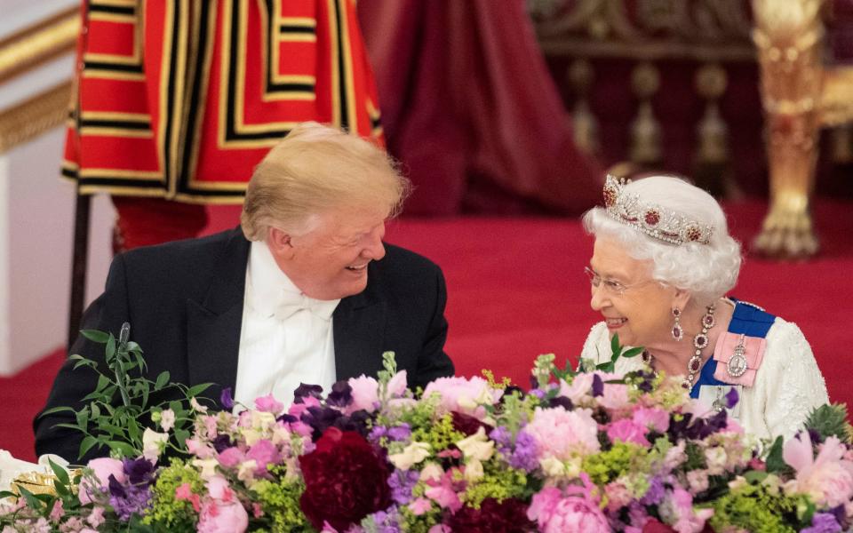 Former US president Donald Trump and Queen Elizabeth II laughing during the State Banquet at Buckingham Palace in June 2019 - Dominic Lipinski/Pool Photo via AP