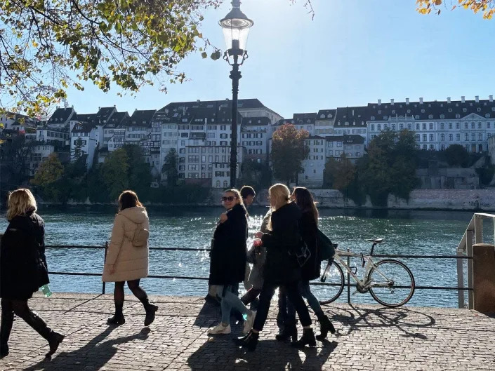 swiss people walking by river, group of pedestrians