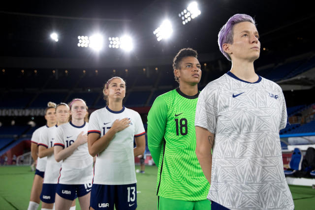Megan Rapinoe (right) stands next to her United States teammates for the national anthem prior to their quarterfinal match against Netherlands on July 30. (Laurence Griffiths/Getty Images)