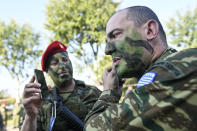 Officers from the Greek military special forces prepare for a parade at the northern port city of Thessaloniki, Greece, Thursday, Oct. 28, 2021 .The parade is held to celebrate Greece's refusal to align itself with a belligerent fascist Italy in 1940 and instead fight a much stronger opponent, a decision which dragged it into World War II and eventually led to a brutal occupation by Nazi Germany. (AP Photo/Giannis Papanikos)