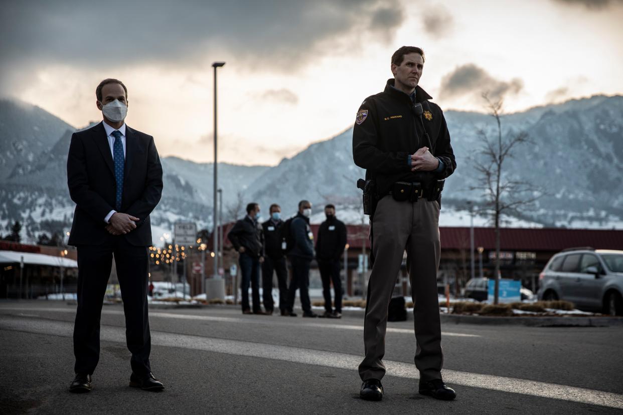 Law enforcement officers stand by during a news conference outside of King Soopers grocery store where a gunman opened fire on March 22, 2021, in Boulder, Colorado.