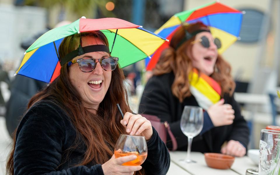 Members of the public enjoy a drink outside at The Still & West pub at Spice Island on -  Finnbarr Webster / Getty