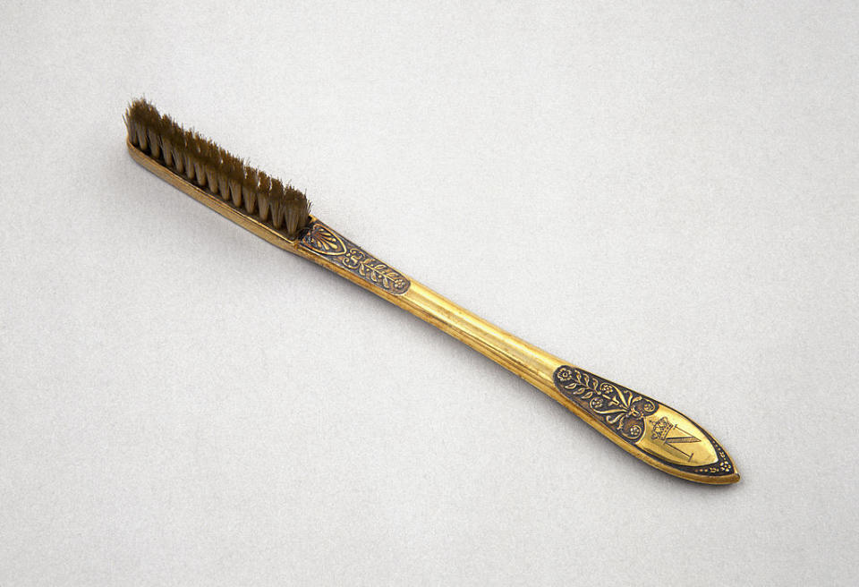 The bottom of the toothbrush is engraved with the letter N, and the head with bristles is significantly larger than the toothbrushes of today