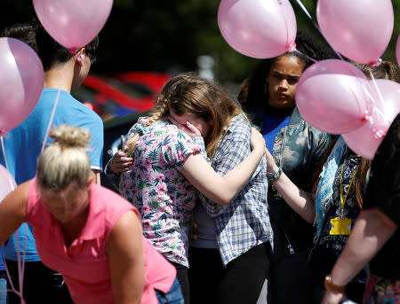 Pupils react outside Tottington high school, after viewing flowers in memory of schoolmate Olivia Campbell who was killed during the Manchester Arena attack, Bury, Manchester, Britain, May 26, 2017. REUTERS/Andrew Yates