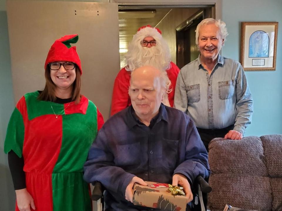 Tricor employees in the guise of Santa's elves deliver some joy to residents at Hilltop Villa in Wooster on Monday.