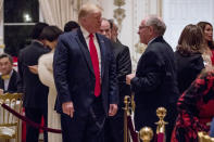 President Donald Trump speaks to attorney Alan Dershowitz, right, as he arrives for Christmas Eve dinner at Mar-a-lago in Palm Beach, Fla., Tuesday, Dec. 24, 2019. (AP Photo/Andrew Harnik)