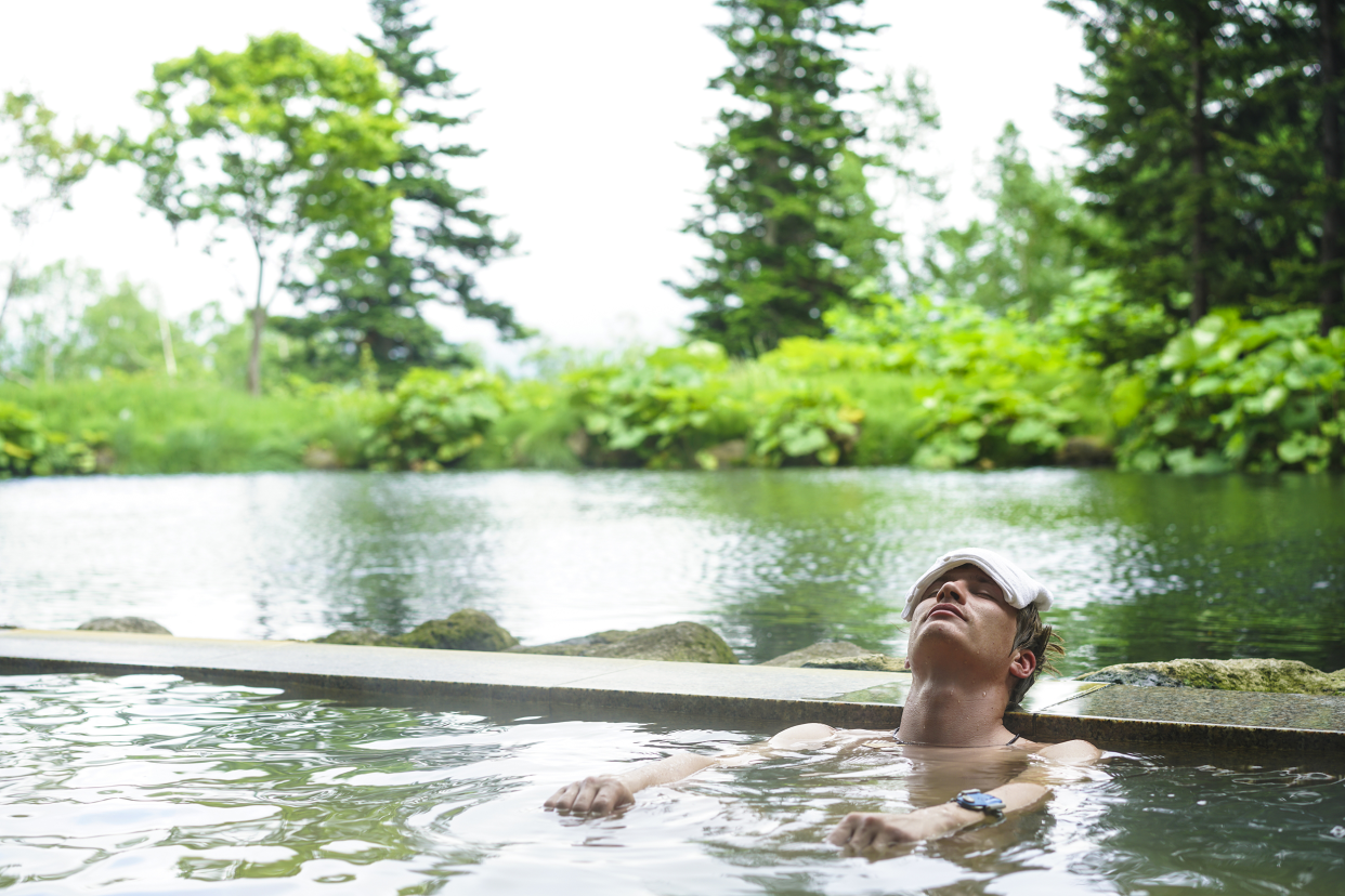 Man soaking in Japanese hot springs