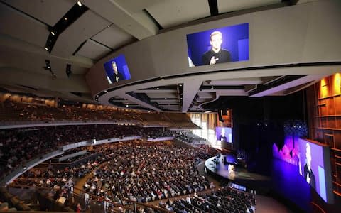 A pastor can be seen projected on several televisions in one 7,000-seat Willow Creek Community church in Illinois - Credit: Reuters 