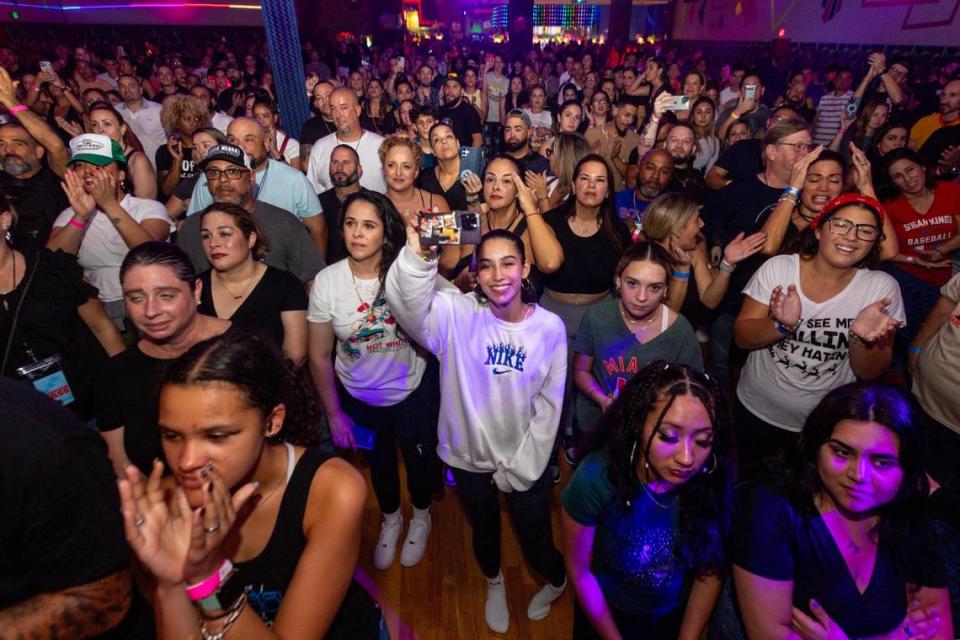 The crowd reacts to owner and operator of Super Wheels Tom Mitchell during a speech at a skating party to mark the official closing in Miami, Florida, on Saturday, November 25, 2023.