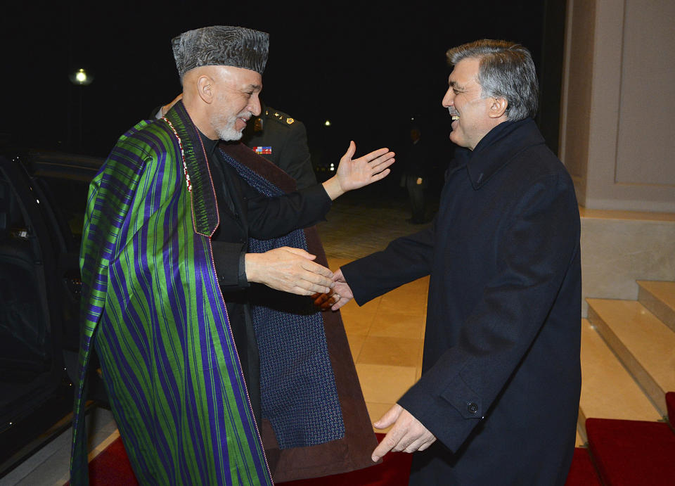 In this photo taken late Wednesday, Feb. 12, 2014 and released by the Turkish Presidency Press Office, Turkish President Abdullah Gul, right, greets his Afghan counterpart Hamid Karzai in Ankara, Turkey. Karzai and Pakistani Prime Minister Nawaz Sharif are in Turkey for the 8th Afghanistan-Pakistan-Turkey Trilateral Summit. (AP Photo/Mustafa Oztartan, Turkish Presidency Press Office)