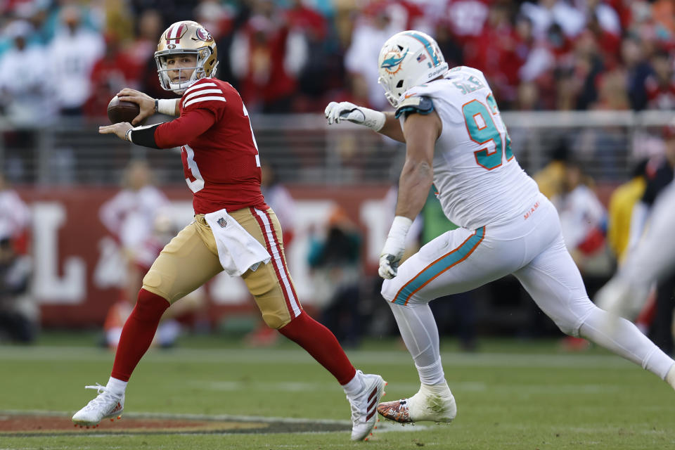 San Francisco 49ers quarterback Brock Purdy, left, passes against Miami Dolphins defensive tackle Zach Sieler during the first half of an NFL football game in Santa Clara, Calif., Sunday, Dec. 4, 2022. (AP Photo/Jed Jacobsohn)