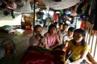 For many Vietnamese migrant workers living on Hanoi's Red River, the camaraderie that comes with selling fruit brings fragments of comfort