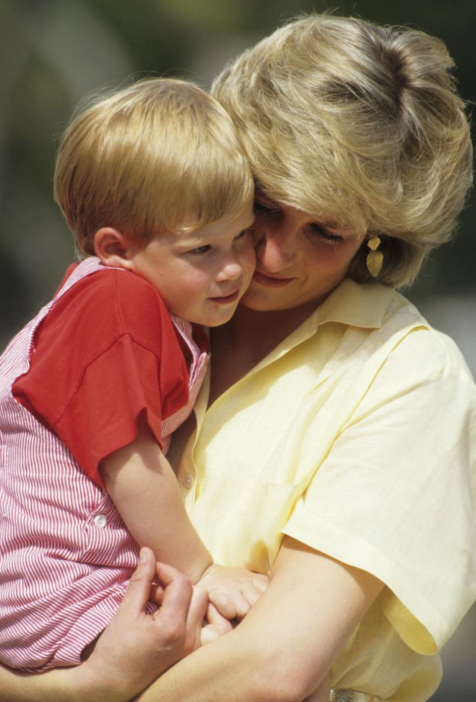 <p>Princess Diana holds her nearly 3-year-old son, Prince Harry, while on holiday in Majorca, Spain in August 1987. In the same HBO documentary released in 2017, Harry said he can still feel Diana's hugs. "I miss that, I miss that feeling. I miss that part of a family, I miss having that mother...to be able to give you those hugs and give you that compassion that I think everybody needs."</p>