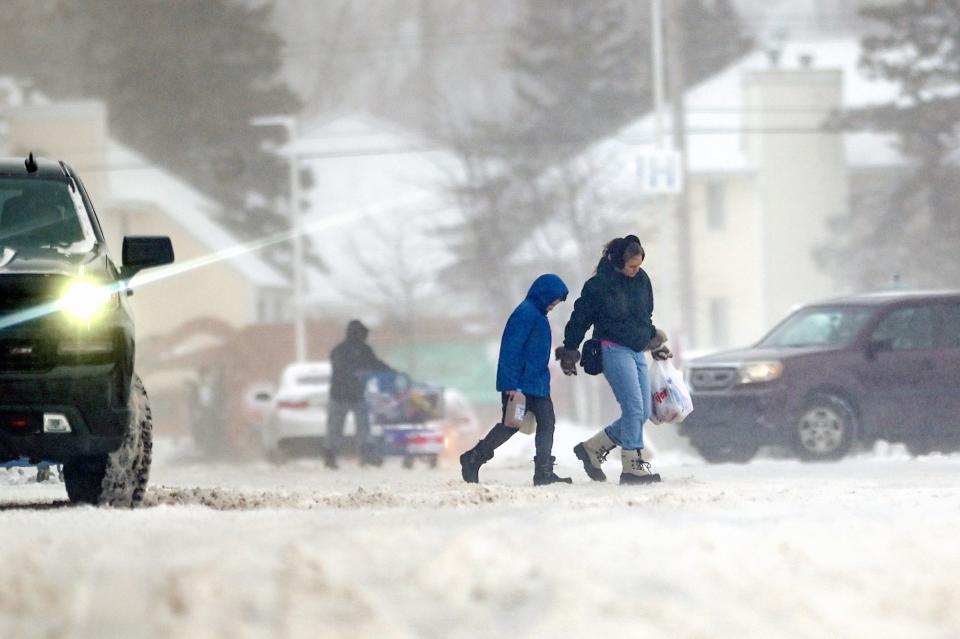 Shoppers brave the elements at the Meijer on Lake Lansing Road on Friday, Dec. 23, 2022, in East Lansing.