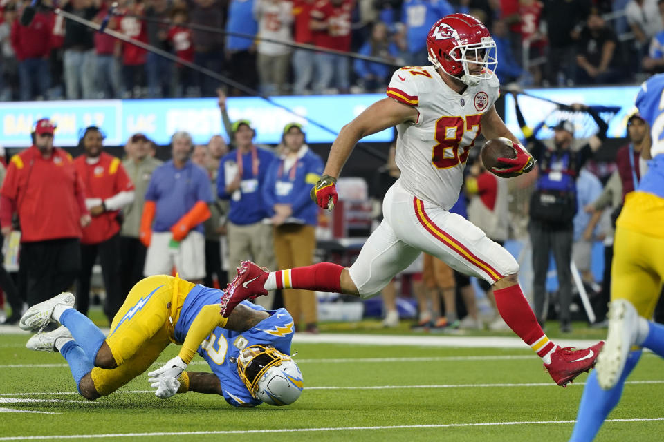 Kansas City Chiefs tight end Travis Kelce, right, runs in for a touchdown as Los Angeles Chargers safety Derwin James Jr. falls during the second half of an NFL football game Sunday, Nov. 20, 2022, in Inglewood, Calif. (AP Photo/Jae C. Hong)