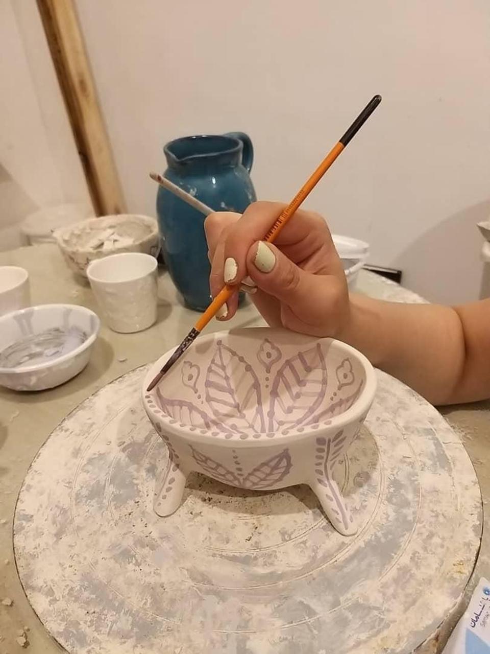 In Lahijan, Iran, painting pottery to pass the time.