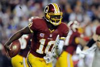 Robert Griffin III #10 of the Washington Redskins scrambles with the ball in the second half against the New York Giants at FedExField on December 3, 2012 in Landover, Maryland. (Photo by Patrick McDermott/Getty Images)