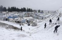 Syrian refugees play with snow during a winter storm in Zahle town, in the Bekaa Valley December 11, 2013. The worst of winter is yet to come for 2.2 million refugees living outside Syria and millions more displaced inside the country. A storm named Alexa is sweeping across Syria and Lebanon, bringing with it high winds and freezing temperatures - and marking the beginning of the third winter since the Syrian conflict began in March 2011. In the tented settlement a few kilometres from the border in Lebanon's Bekaa Valley, more than 1,000 people live in rudimentary shelters. REUTERS/Mohamed Azakir (LEBANON - Tags: POLITICS CIVIL UNREST CONFLICT SOCIETY IMMIGRATION ENVIRONMENT ENERGY TPX IMAGES OF THE DAY)