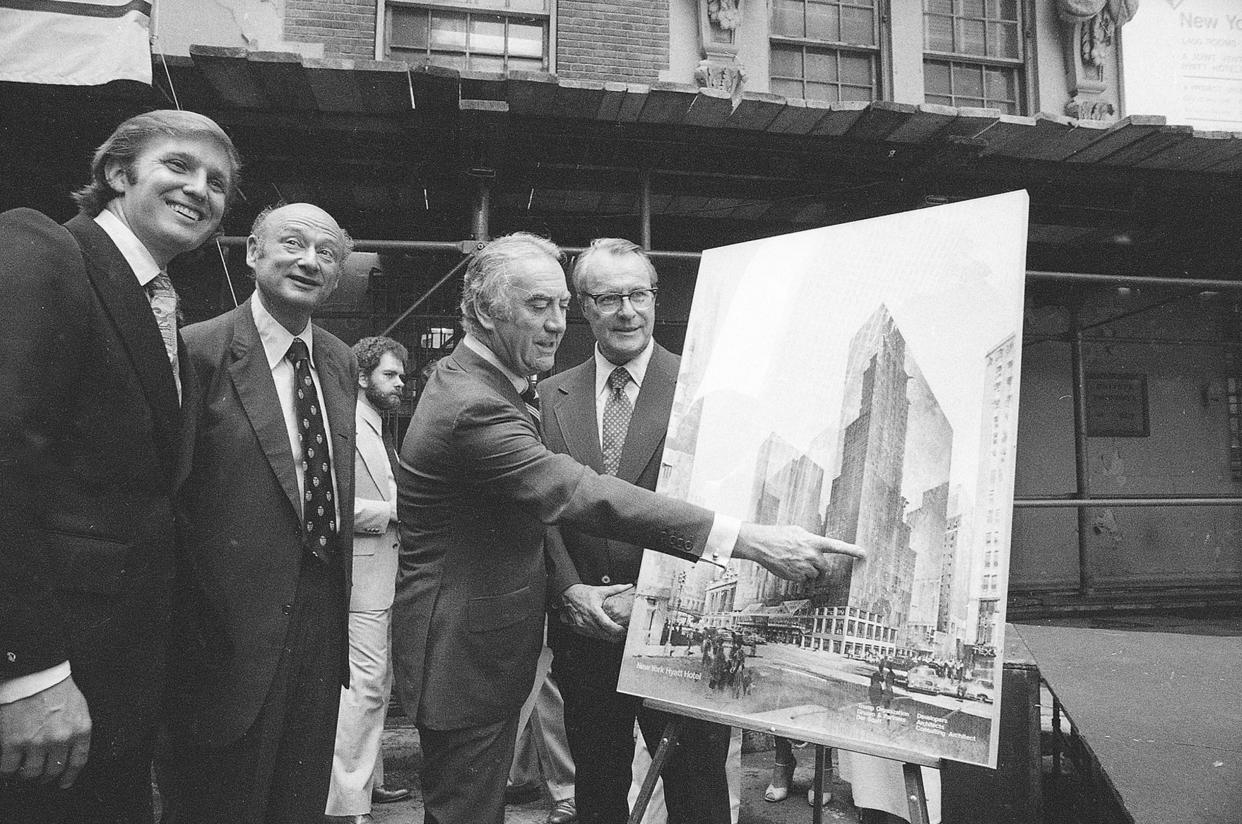 Governor Hugh Carey points to an artists' conception of the new New York Hyatt Hotel/Convention facility that will be build on the site of the former Commordore Hotel, on June 28, 1978.  At the launching ceremony are, from left:  Donald Trump, son of the city developer Fred C. Trump; Mayor Ed Koch of New York; Carey; and Robert T. Dormer, executive vice president of the Urban Development Corp.