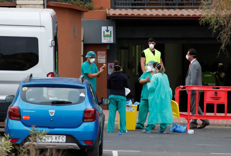 Medical staff prepares to check guests leaving the H10 Costa Adeje Palace, which is on lockdown after the novel coronavirus has been confirmed in Adeje