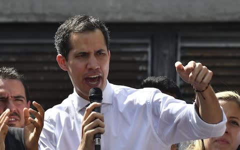  Juan Guaido speaks before a crowd of opposition supporters during an open meeting at the Central University of Caracas - Credit: &nbsp;YURI CORTEZ/&nbsp;AFP