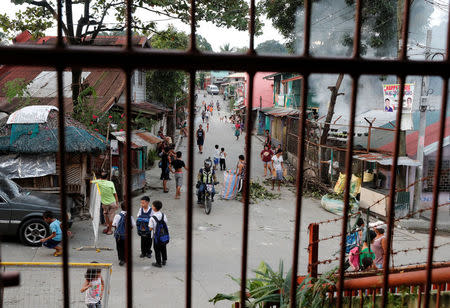 Residents are pictured along a street in Barangay Payatas district in Quezon City, Metro Manila in the Philippines December 11, 2017. REUTERS/Erik De Castro