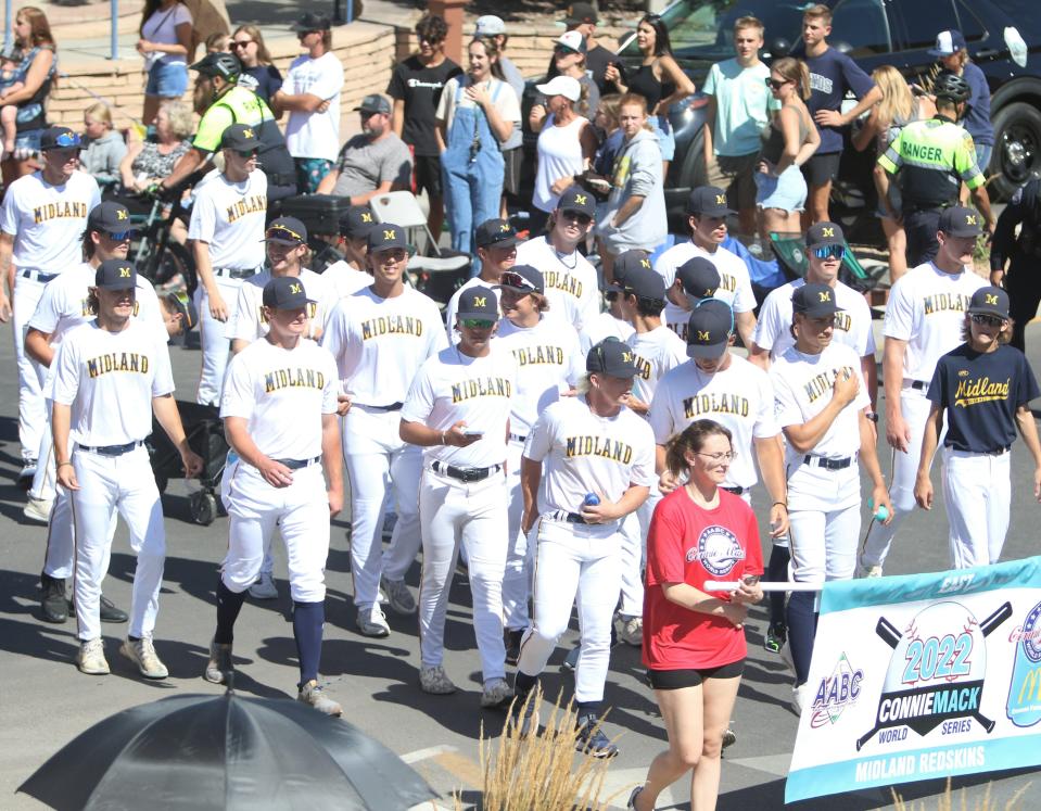 Members of the Midland Baseball team greet fans and walk down Main Street in front of more than a thousand fans who turned out for the Connie Mack World Series Parade, Thursday, July 21, 2022.