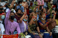 Anti-coup protesters shout slogans in Yangon, Myanmar, Thursday, Feb. 25, 2021. Social media giant Facebook announced Thursday it was banning all accounts linked to Myanmar's military as well as ads from military-controlled companies in the wake of the army's seizure of power on Feb. 1. (AP Photo)