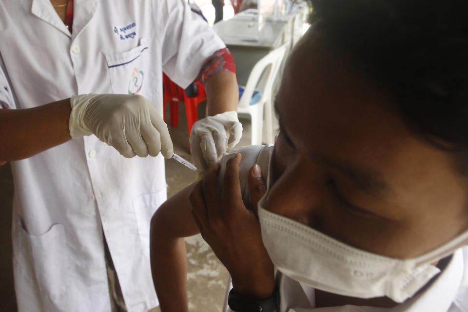 A boy receive a third dose of the Sinovac's COVID-19 vaccine at a Krang Thnung health center outside Phnom Penh, Cambodia, Monday, Nov. 15, 2021. Cambodia reopened its borders to fully vaccinated travelers Monday, two weeks earlier than planned as the country emerges from a lengthy lockdown, bolstered by one of the world's highest rates of immunization against COVID-19. (AP Photo/Heng Sinith)