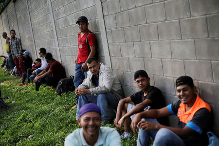 Hondurans wait to leave with a new caravan of migrants, set to head to the United States, at a bus station in San Pedro Sula, Honduras January 14, 2019. REUTERS/Jorge Cabrera