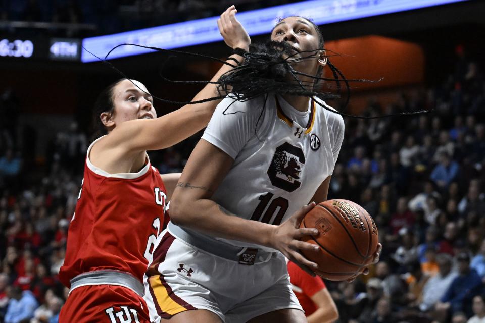 South Carolina center Kamilla Cardoso (10) looks to shoot as Utah forward Jenna Johnson, left, defends in the second half of an NCAA college basketball game, Sunday, Dec. 10, 2023, in Uncasville, Conn. | Jessica Hill, Associated Press