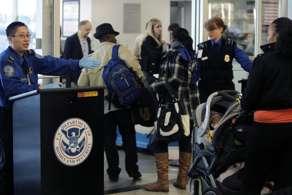 FILE - In this Nov. 23, 2010 file photo, travelers make their way through a security checkpoint at LaGuardia Airport in New York. In 2013, 25 gun-packing out-of-towners were arrested on felony weapons charges for traveling armed at New York's busy LaGuardia and Kennedy airports. Such strict enforcement of New York's tough gun laws is intended to send a message not to bring firearms to New York in the first place, and that message may be getting through. (AP Photo/Seth Wenig, File)