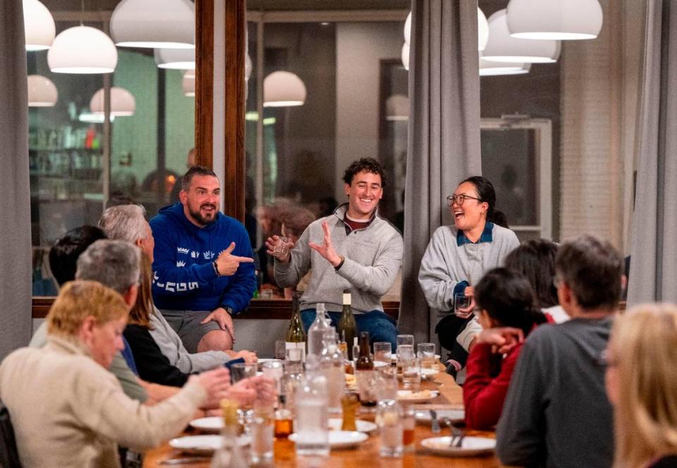 Localis chef Chris Barnum-Dann, left, and Binochoyaki chef chef Toki Sawada, right, laugh with Sacramento Bee reporter Benjy Egel, center, during a book signing event for Egel’s cookbook “Sacramento Eats” on Wednesday at Masullo restaurant in Land Park.