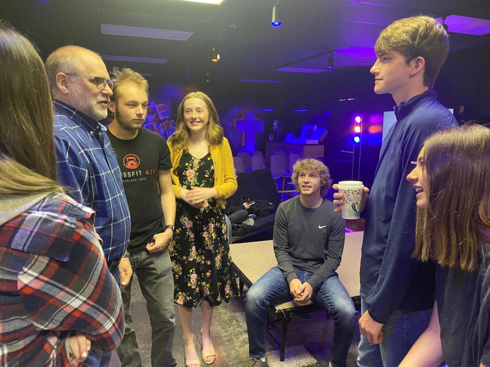 Dave Wright, talking with teens on a recent Sunday at Grace Church, has been volunteering at the Ashland church for more than 30 years, particularly with teens.