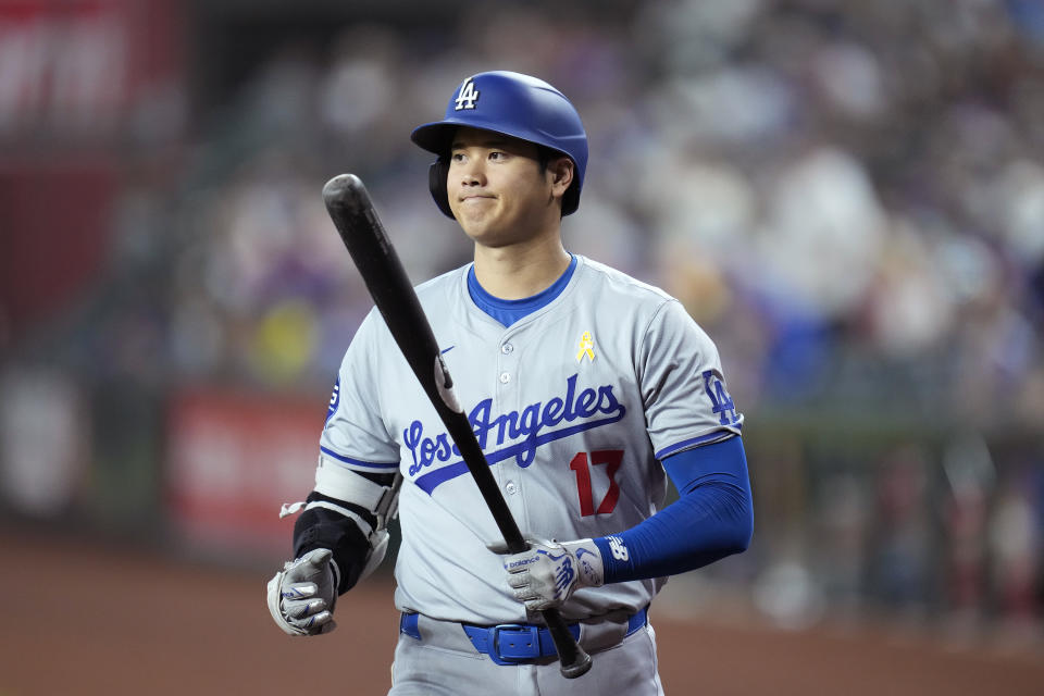 Los Angeles Dodgers designated hitter Shohei Ohtani, of Japan, walks to home plate to bat prior to a baseball game against the Arizona Diamondbacks, Sunday, Sept. 1, 2024, in Phoenix. (AP Photo/Ross D. Franklin)