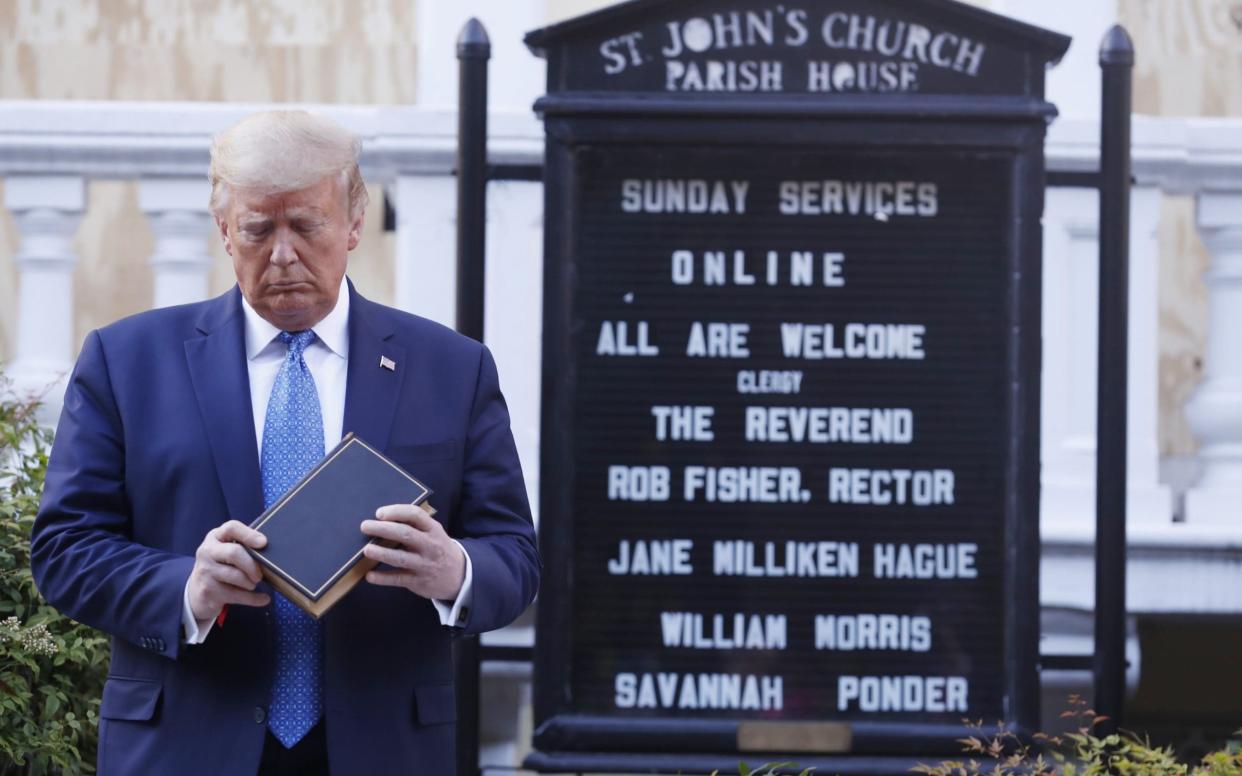 Donald Trump posed outside the boarded up St John's Church - BLOOMBERG