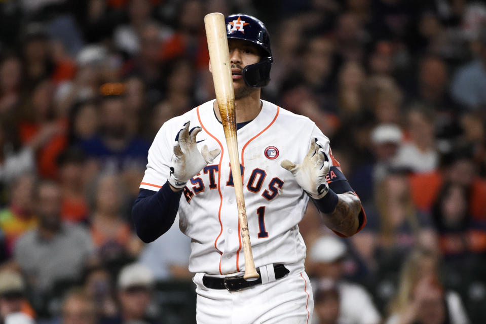 Houston Astros' Carlos Correa reacts after striking out during the third inning of a baseball game against the Texas Rangers, Saturday, May 15, 2021, in Houston. (AP Photo/Eric Christian Smith)