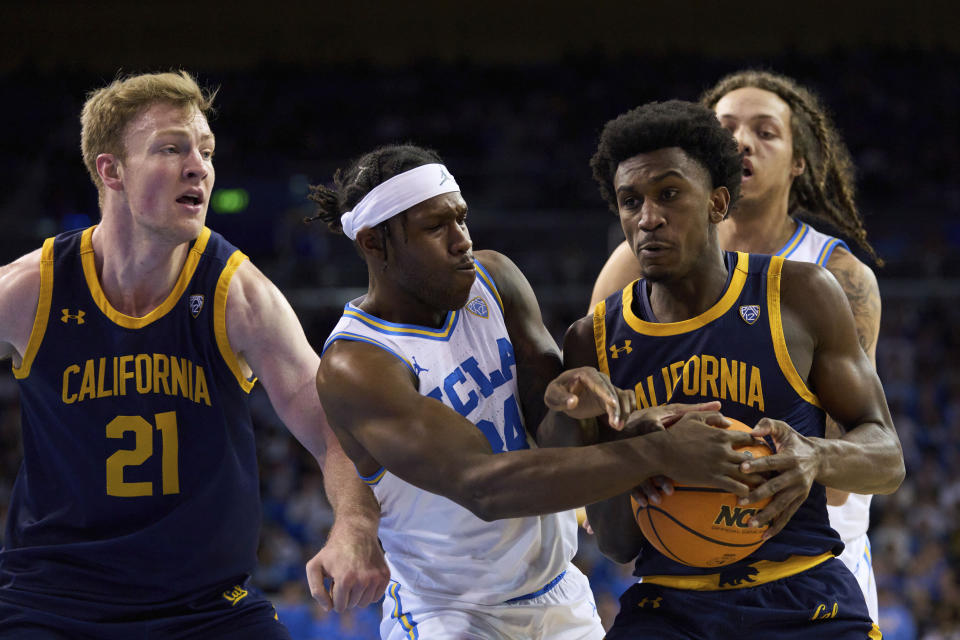 UCLA guard David Singleton tries to steal the ball from California guard Marsalis Roberson as California forward Lars Thiemann watches during the first half of an NCAA college basketball game Saturday, Feb. 18, 2023, in Los Angeles. (AP Photo/Allison Dinner)