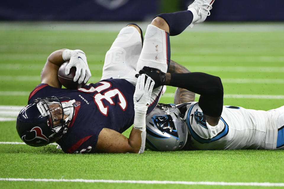 Houston Texans running back Phillip Lindsay (30) is tackled by Carolina Panthers cornerback Jaycee Horn during the second half of an NFL football game Thursday, Sept. 23, 2021, in Houston. (AP Photo/Justin Rex)