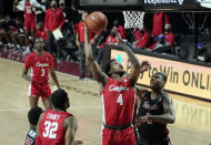 Houston's Justin Gorham (4) takes a shot over Temple's J.P. Moorman II (4) in the first half of an NCAA college basketball game, Saturday, Jan. 23, 2021, in Philadelphia. (AP Photo/Michael Perez)