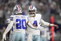 Dallas Cowboys quarterback Dak Prescott (4) celebrates a touchdown by Tony Pollard (20) during the second half of an NFL football game against the Indianapolis Colts, Sunday, Dec. 4, 2022, in Arlington, Texas. (AP Photo/Tony Gutierrez)