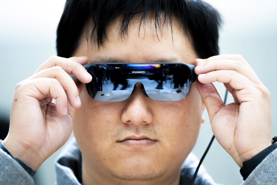 A visitor tests Huawei vision glasses during the Mobile World Congress 2023 in Barcelona, Spain, Monday, Feb. 27, 2023. The four-day show kicks off Monday in a vast Barcelona conference center. It is the world's biggest and most influential meeting for the mobile tech industry. (AP Photo/Joan Mateu Parra)