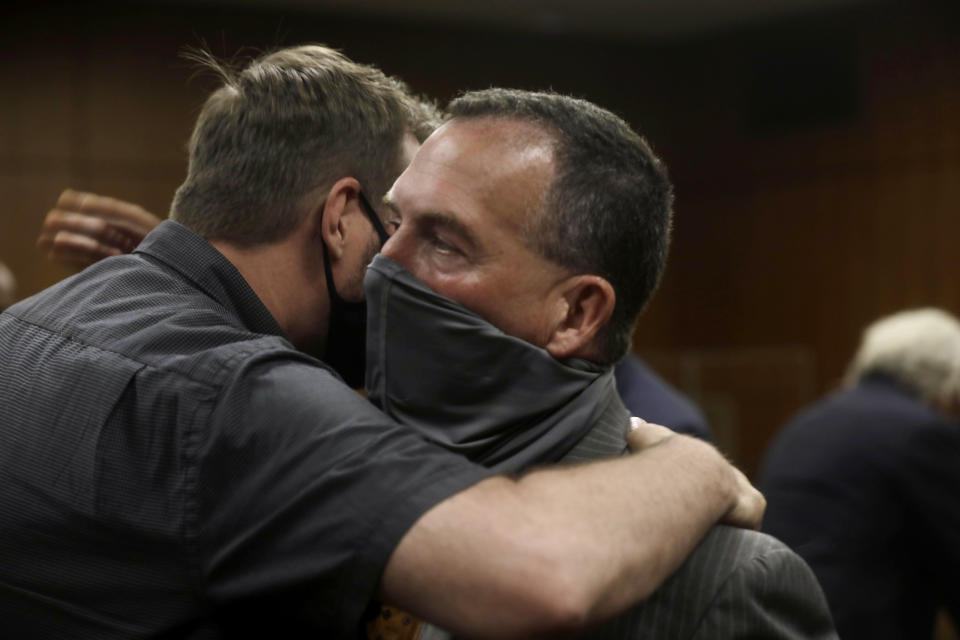 Deputy District Attorney John Lewin, right, is congratulated after Robert Durst convicted Friday, Sept. 17, 2021, in Inglewood, Calif., of murdering Susan Berman 20 years ago. Durst was not in court to hear the verdict read because he was in isolation following an exposure to COVID-19. (Genaro Molina/Los Angeles Times via AP, Pool)