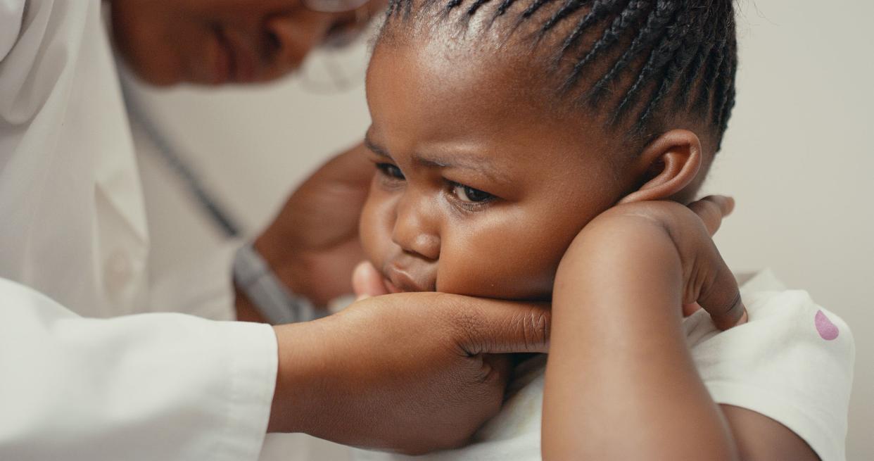 Shot of an adorable little girl having her ears checked during a consultation with a doctor