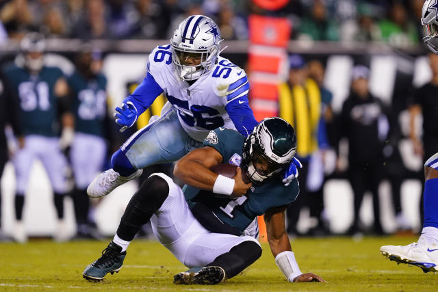 A Dallas Cowboys fan and a Philadelphia Eagles fan pose for a photo before  an NFL football game between the Eagles and Cowboys on Sunday, Oct. 16,  2022, in Philadelphia. (AP Photo/Matt