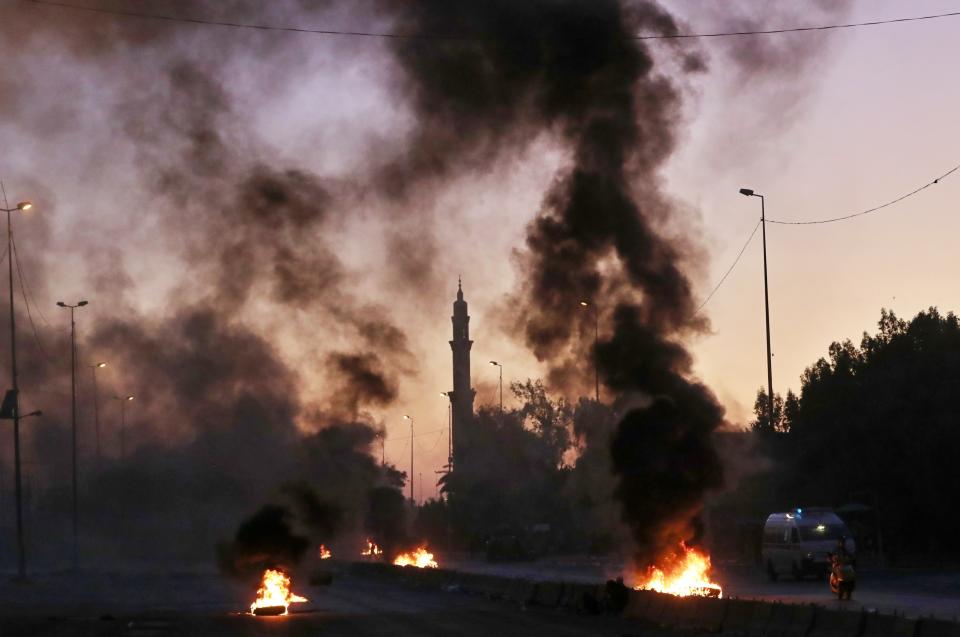 Anti-government protesters set fires and close a street during a demonstration in Baghdad, Iraq, Friday, Oct. 4, 2019. Security forces opened fire at hundreds of anti-government demonstrators Friday in central Baghdad, killing at least 10 protesters and injuring dozens, hours after Iraq's top Shiite cleric warned both sides to end four days of deadly violence "before it's too late." (AP Photo/Khalid Mohammed)