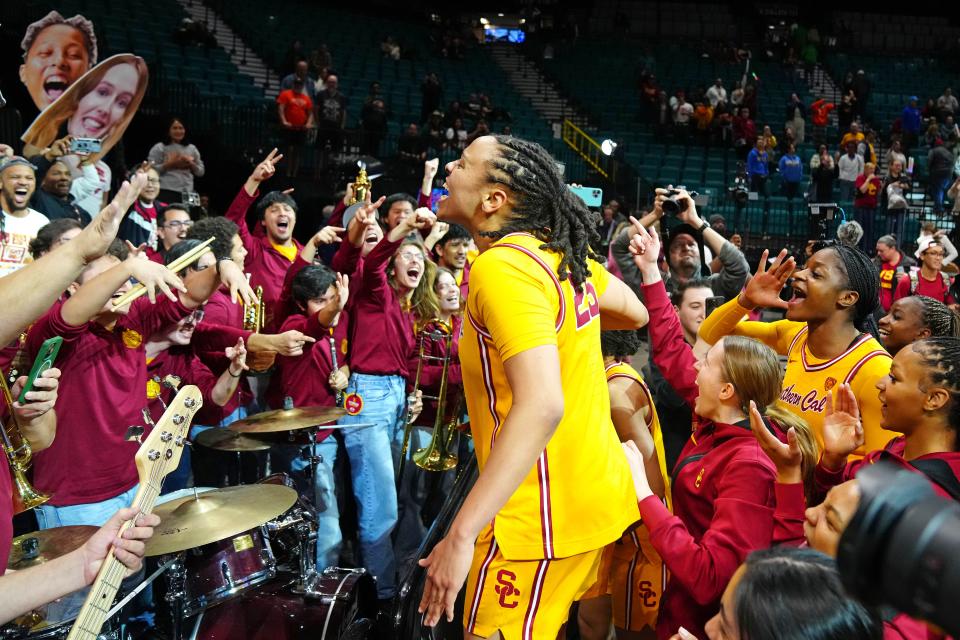 USC guard McKenzie Forbes joins the Trojan Marching Band in making some noise after beating UCLA on March 8.