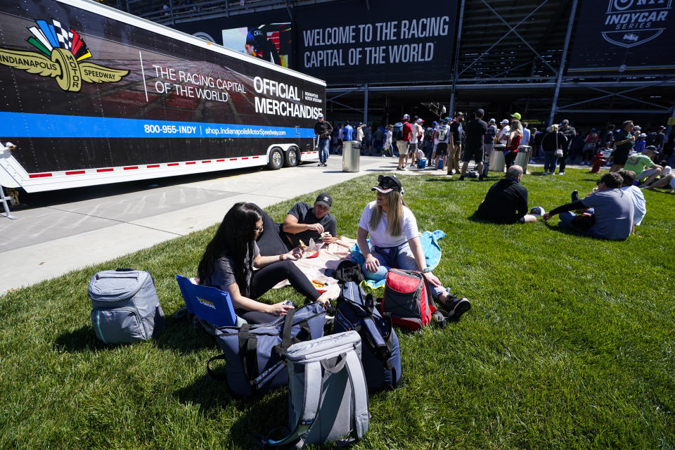 Fans picnic behind the stands before the start the Indianapolis 500 auto race at Indianapolis Motor Speedway in Indianapolis, Sunday, May 30, 2021. (AP Photo/Darron Cummings)