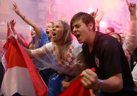 Croatia fans watch the broadcast of the World Cup semi-final match between Croatia and England in the fan zone in Zagreb, Croatia. REUTERS/Antonio Bronic