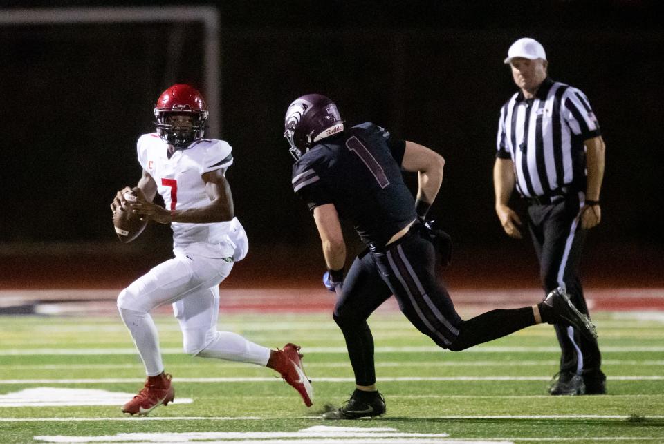 Sep 8, 2023; Scottsdale, AZ, USA; Chaparral quarterback Marcel Jones (7) runs with the ball against Desert Mountain tight end Dillon Hipp (1) at Desert Mountain High SchoolÕs football field in Scottsdale on Sept. 8, 2023.